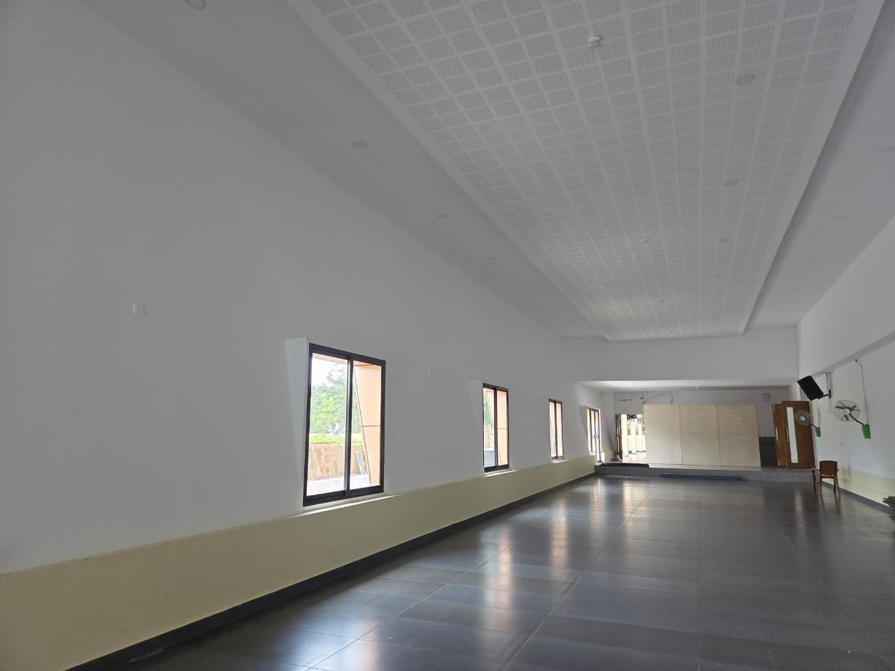 Crown Hall — the spacious, non-air-conditioned hall with windows and a raised platform at one end